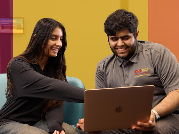 Two students working on a computer